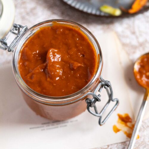 BBQ sauce in a jar on a counter.