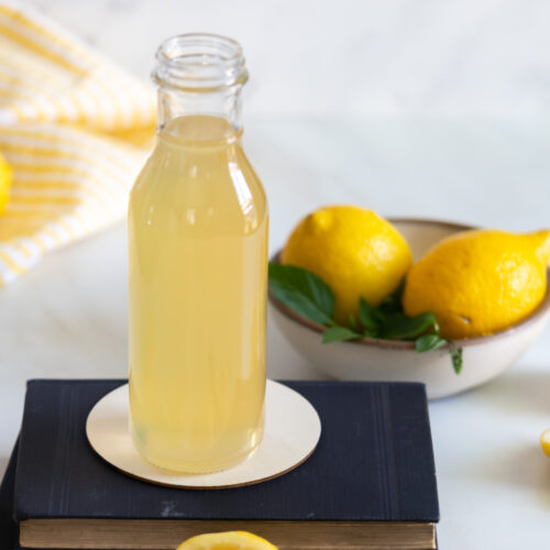 Lemon simple syrup in a bottle.